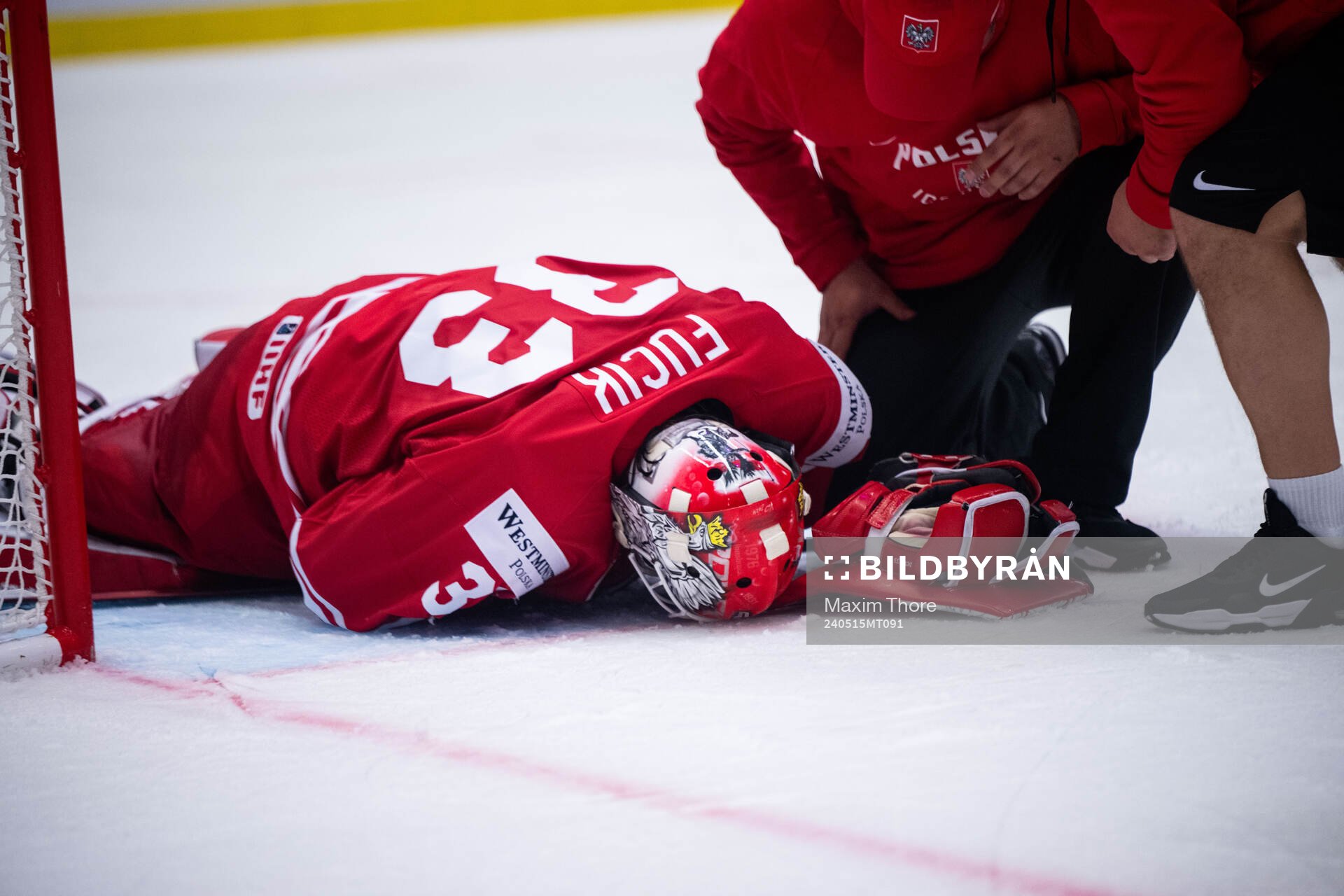Goaltender Tomas Fucik of Poland in pain