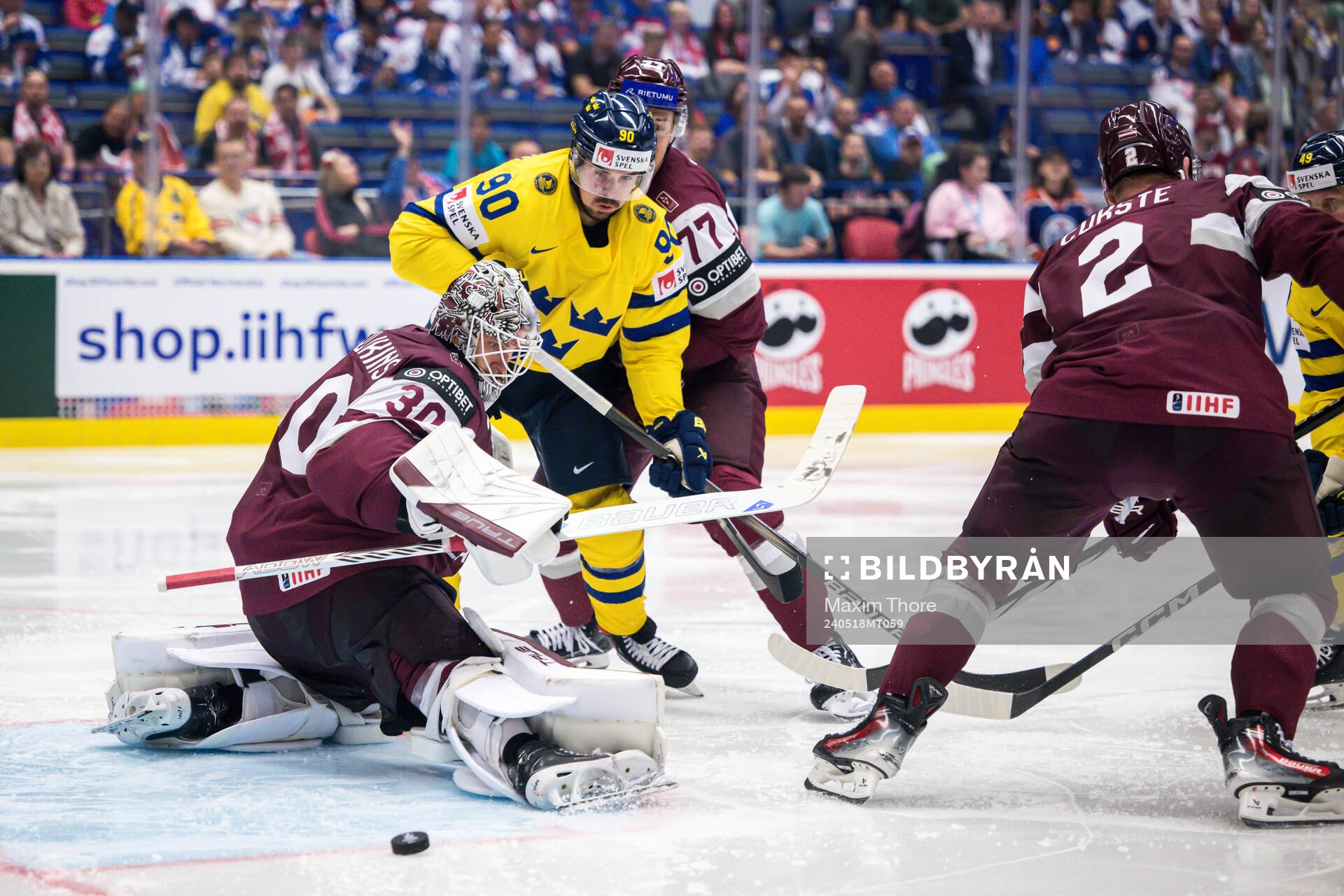 Marcus Johansson of Sweden and goaltender Elvis Merzlikins