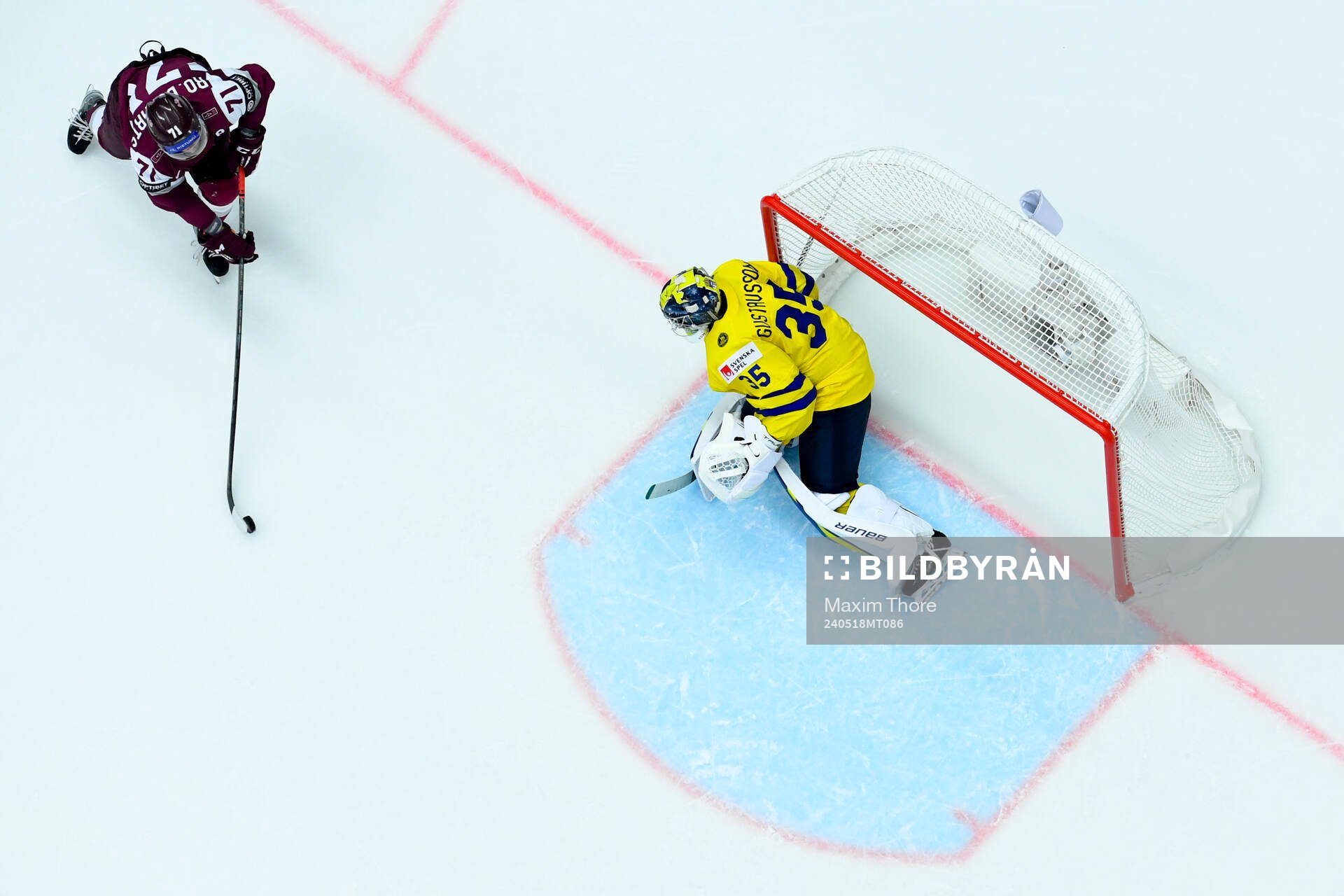 Roberts Bukarts of Latvia and goaltender Filip Gustavsson