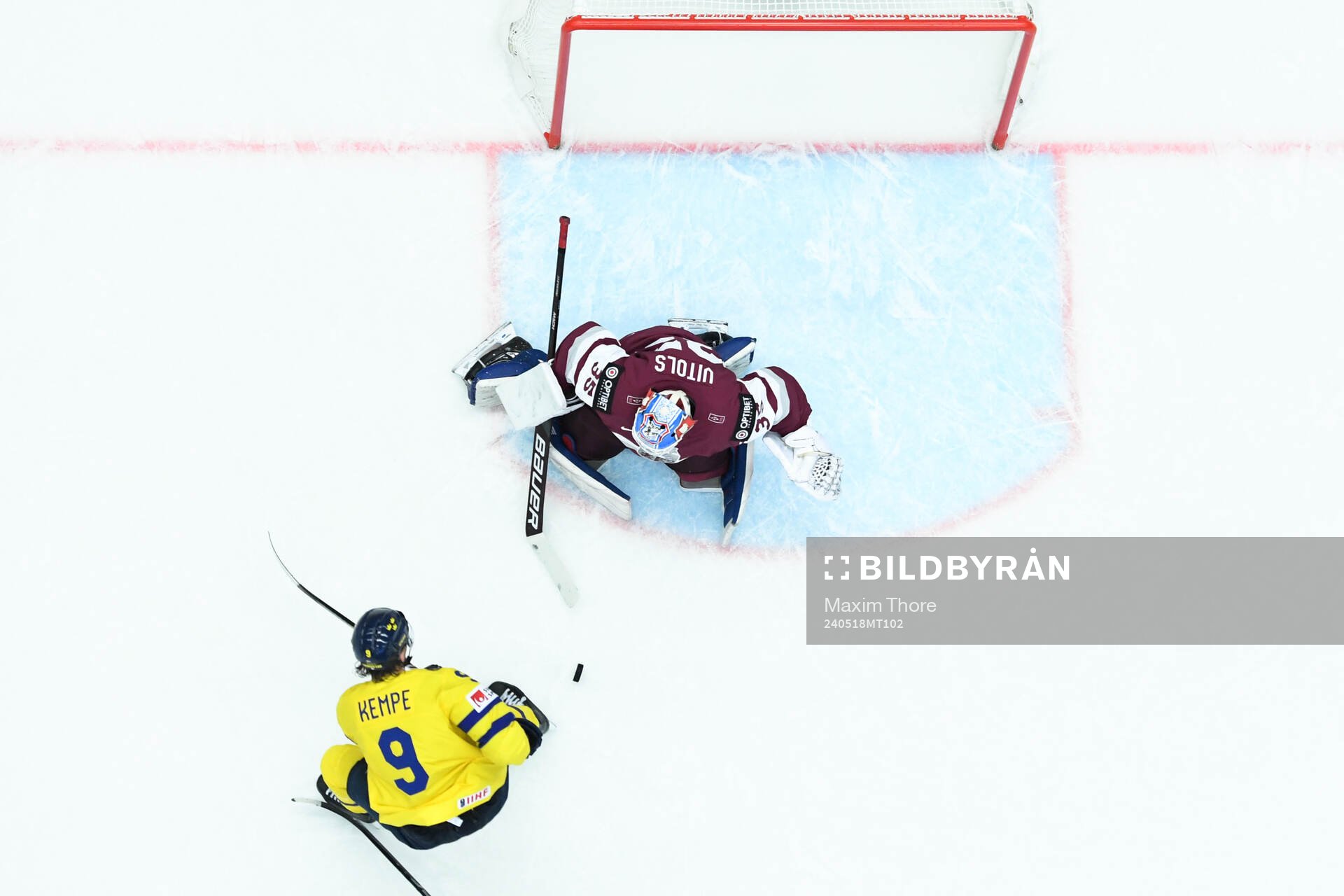 Adrian Kempe of Sweden and goaltender Kristers Gudlevskis