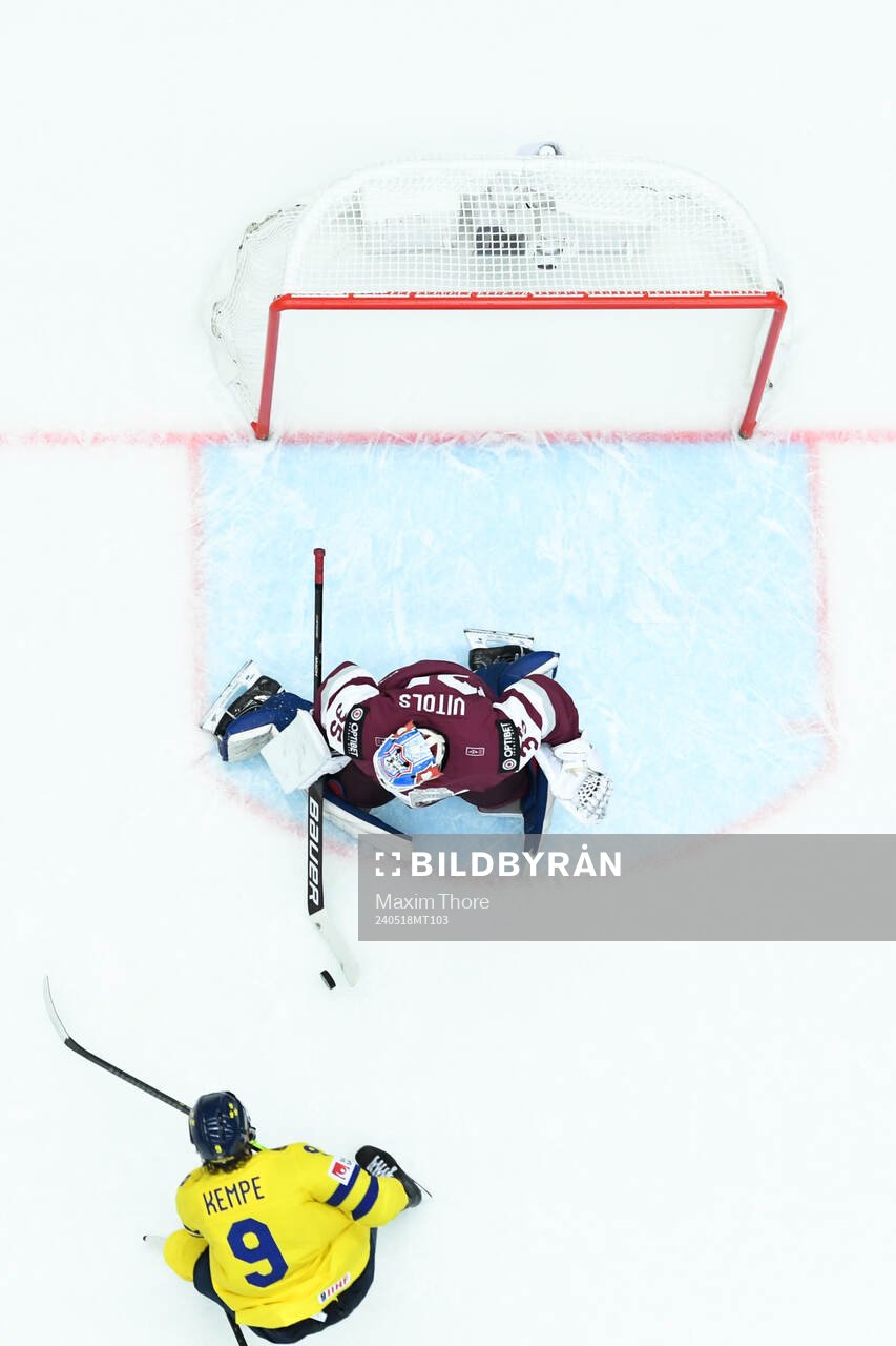 Adrian Kempe of Sweden and goaltender Kristers Gudlevskis