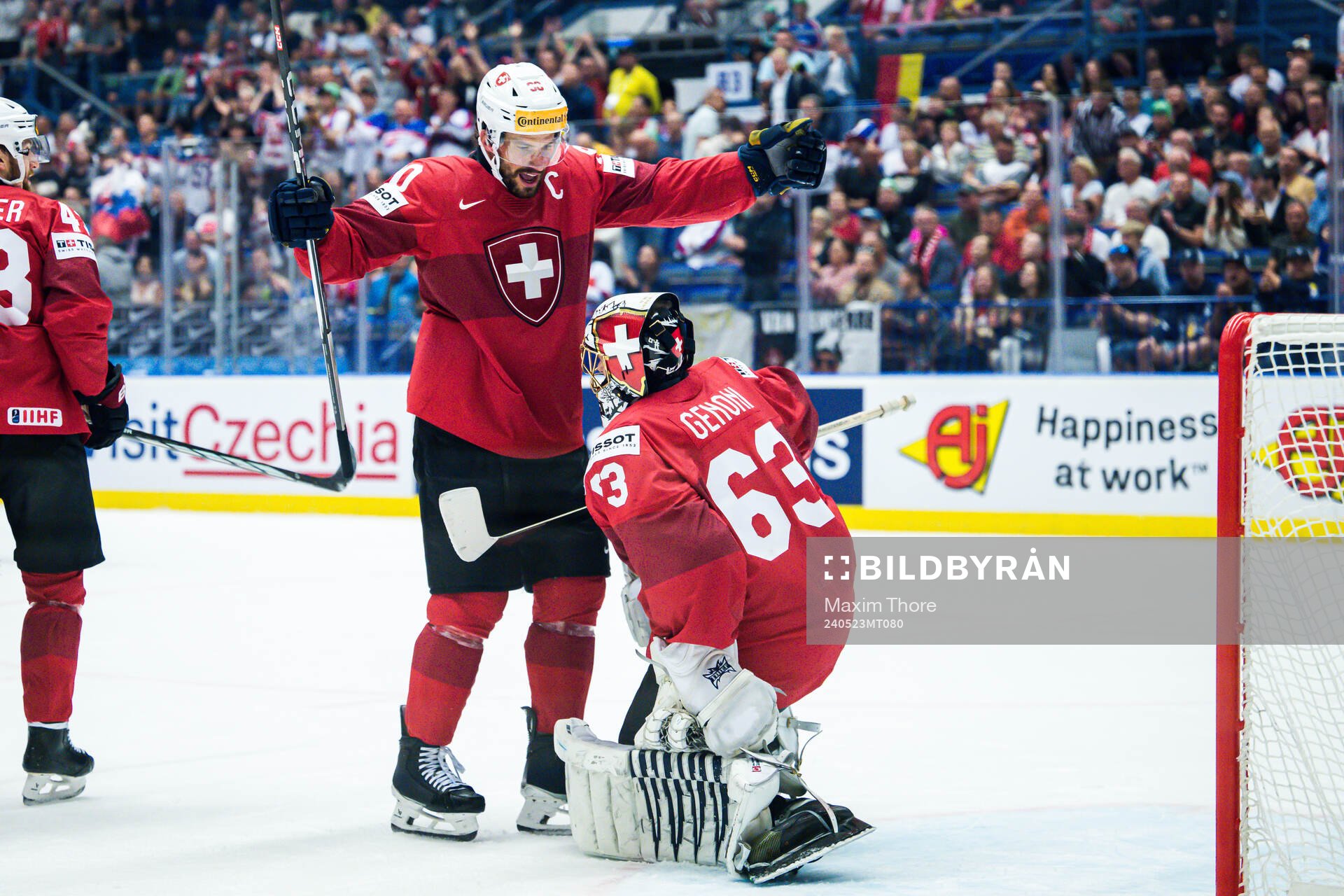 Roman Josi and goaltender Leonardo Genoni celebrates