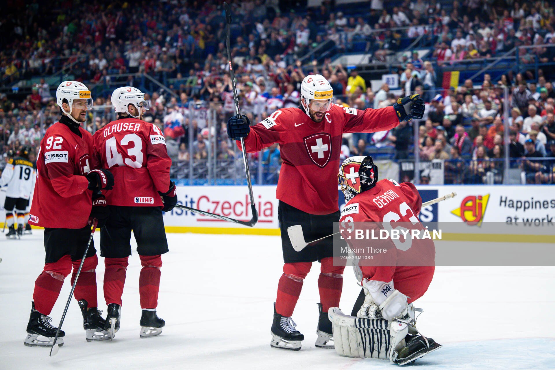 Roman Josi and goaltender Leonardo Genoni of Switzerland