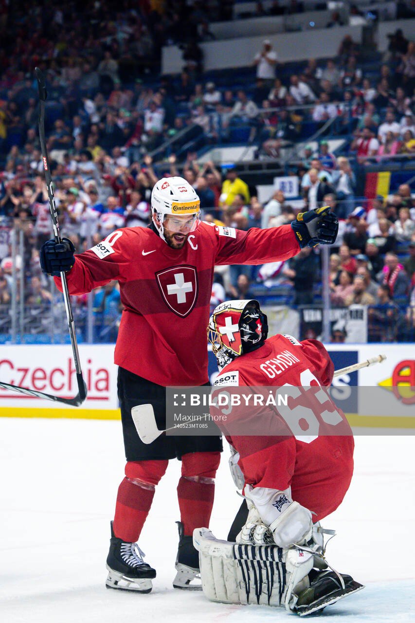 Roman Josi and goaltender Leonardo Genoni of Switzerland