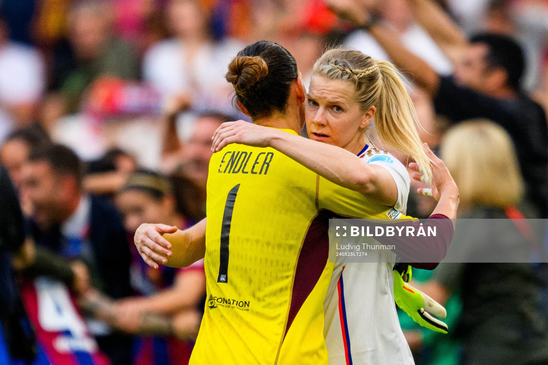 Ada Hegerberg of Lyon hugs goalkeeper Christiane Endler