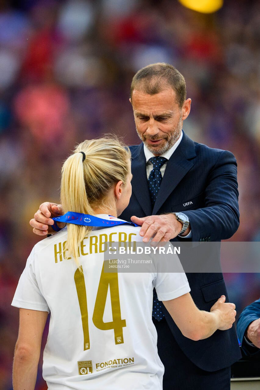UEFA president Aleksander Ceferin hands Ada Hegerberg of