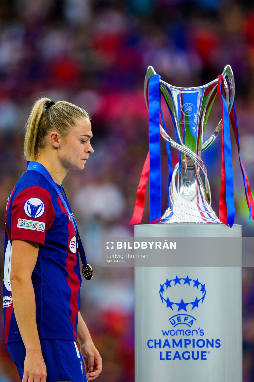 Fridolina Rolfö of Barcelona walks behind the trophy