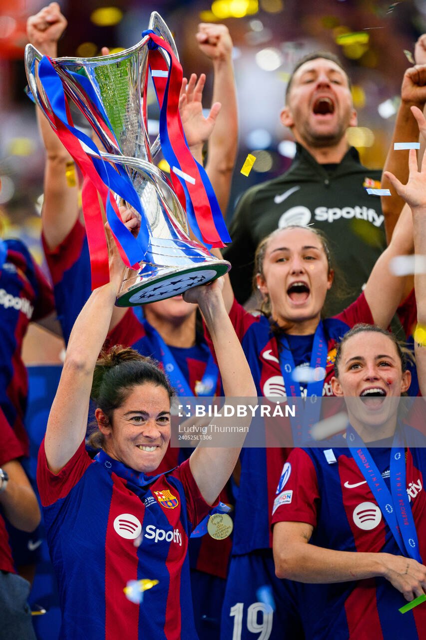 Marta Torrejon of Barcelona lifts the trophy