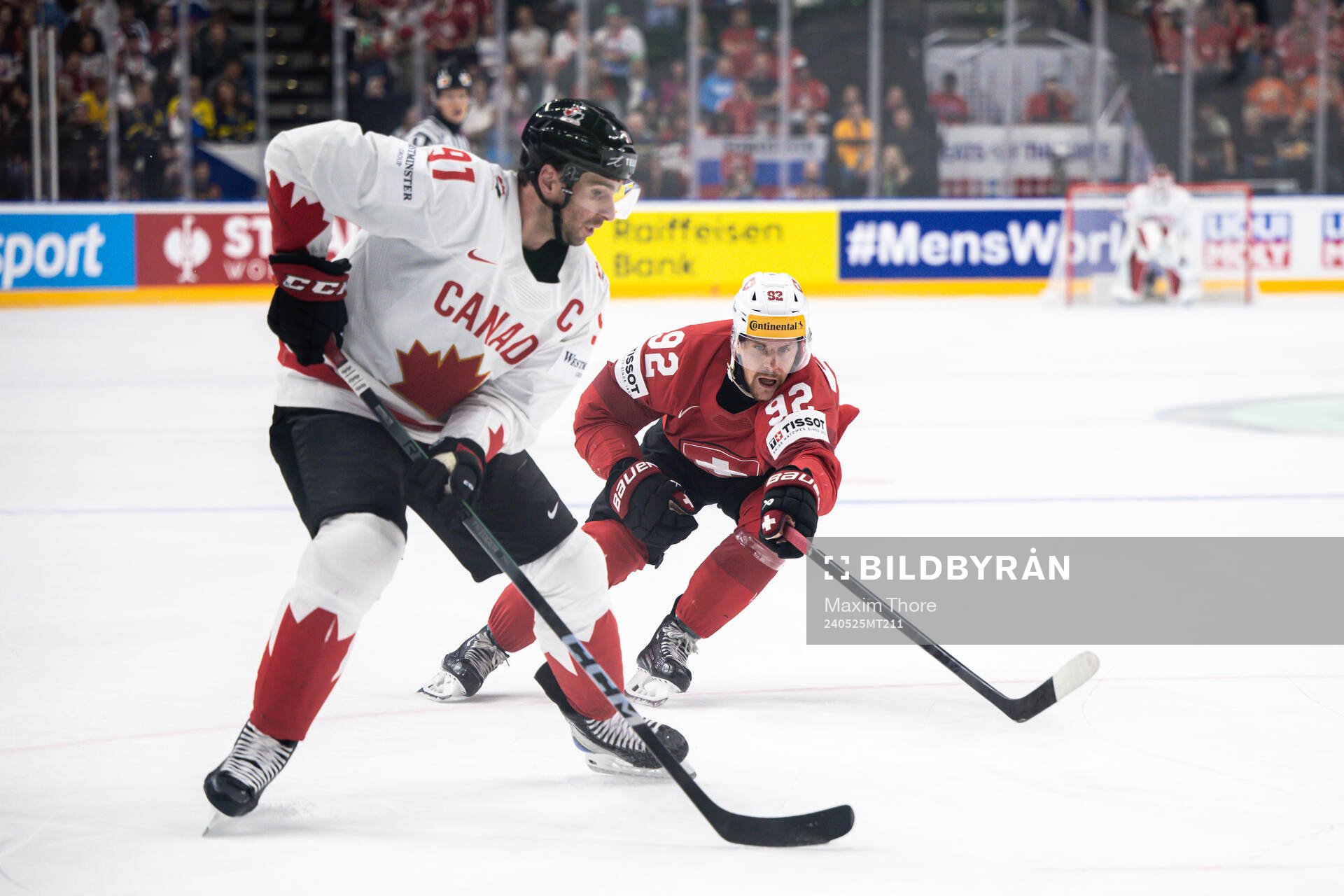 John Tavares of Canada and Gaetan Haas of Switzerland