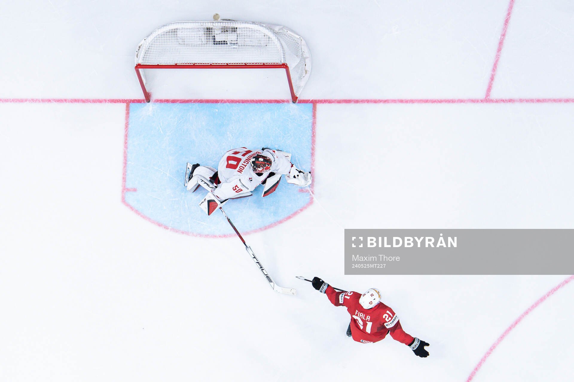 Kevin Fiala of Switzerland scores a goal behind goaltender