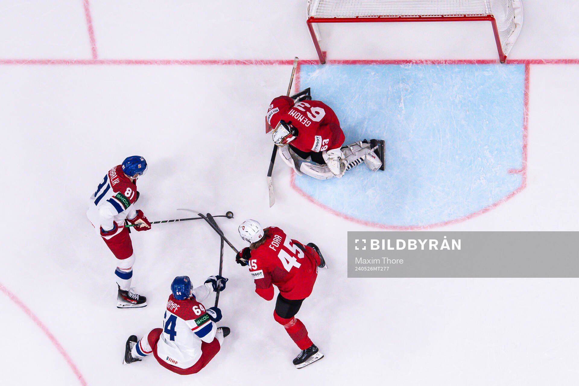 Michael Fora and goaltender Leonardo Genoni of Switzerland