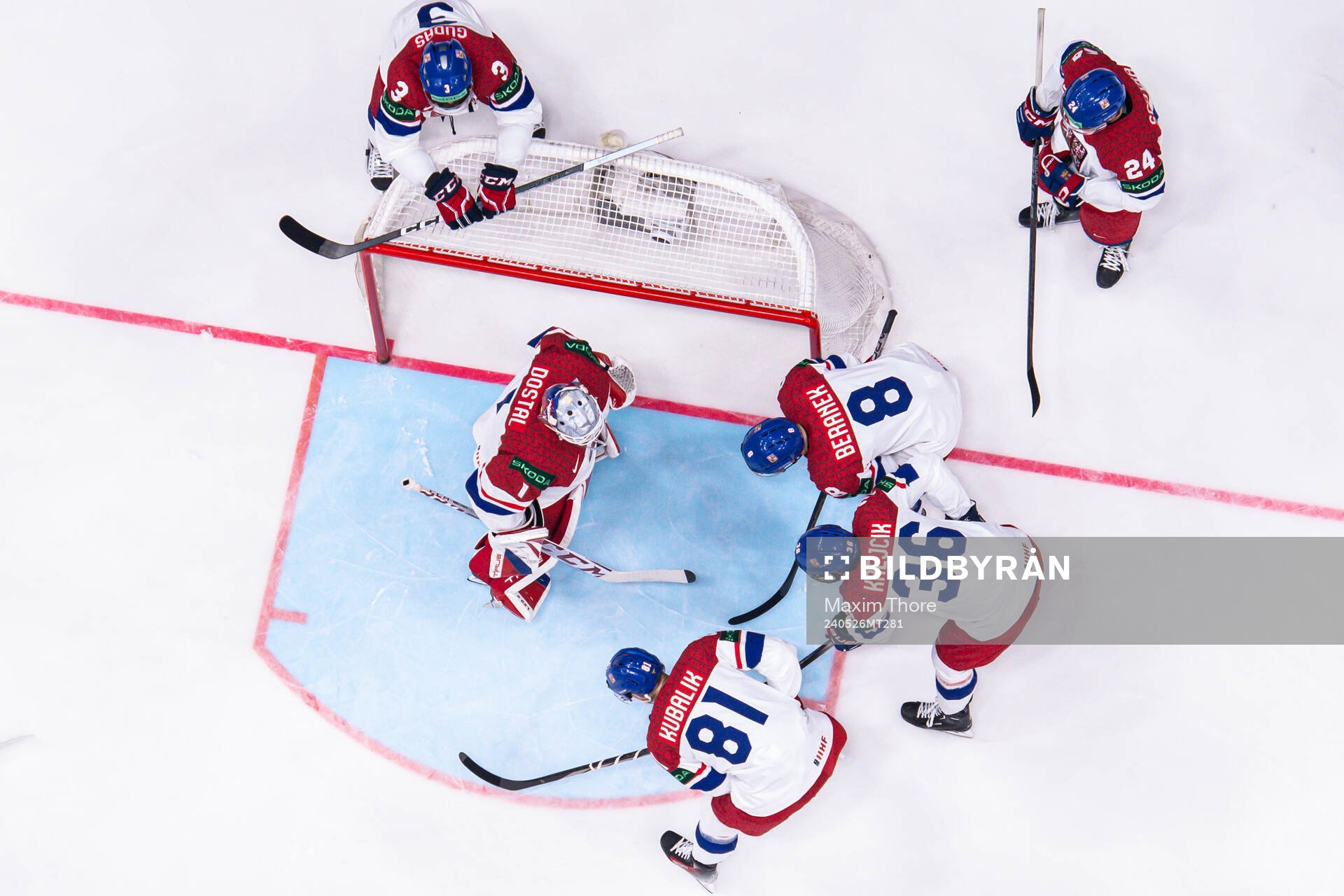 Players of Czech Republic gather around goaltender Lukas