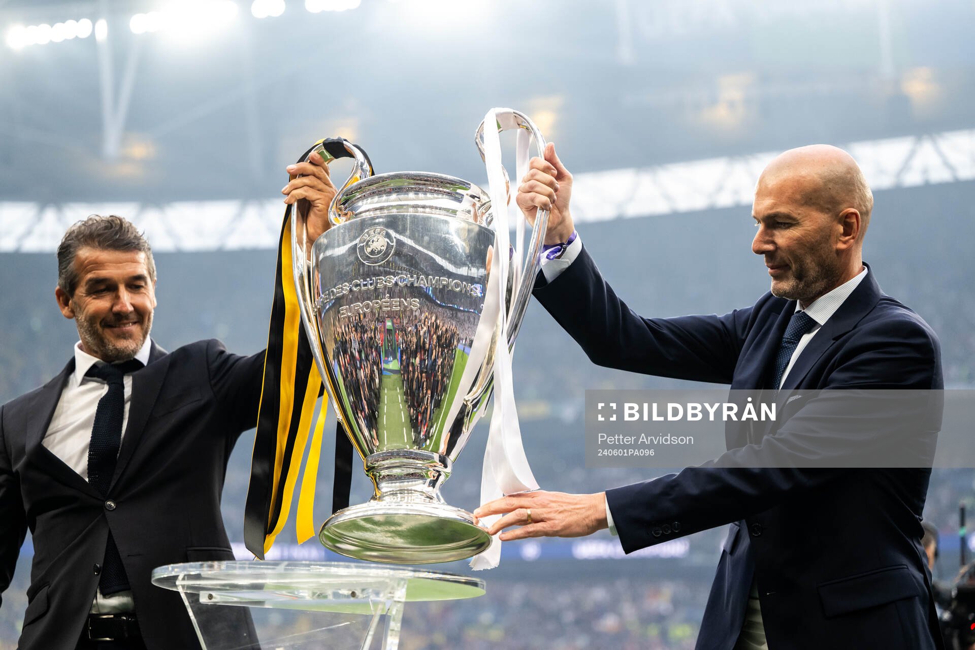 Former players Karl Heinz Riedle and Zinedine Zidane carry