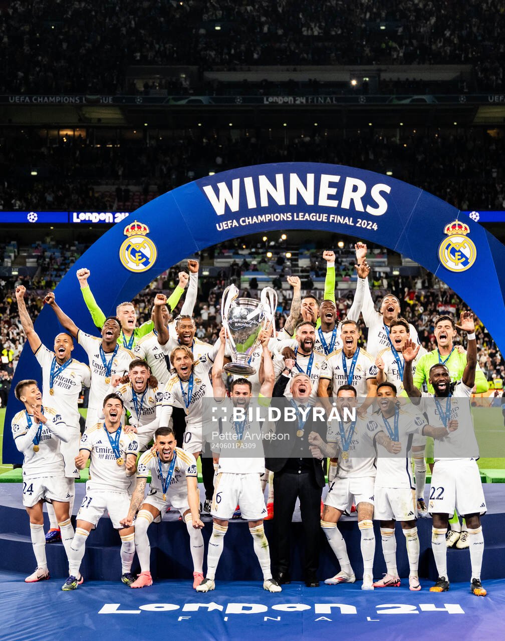Nacho Fernandez of Real Madrid lifts the trophy
