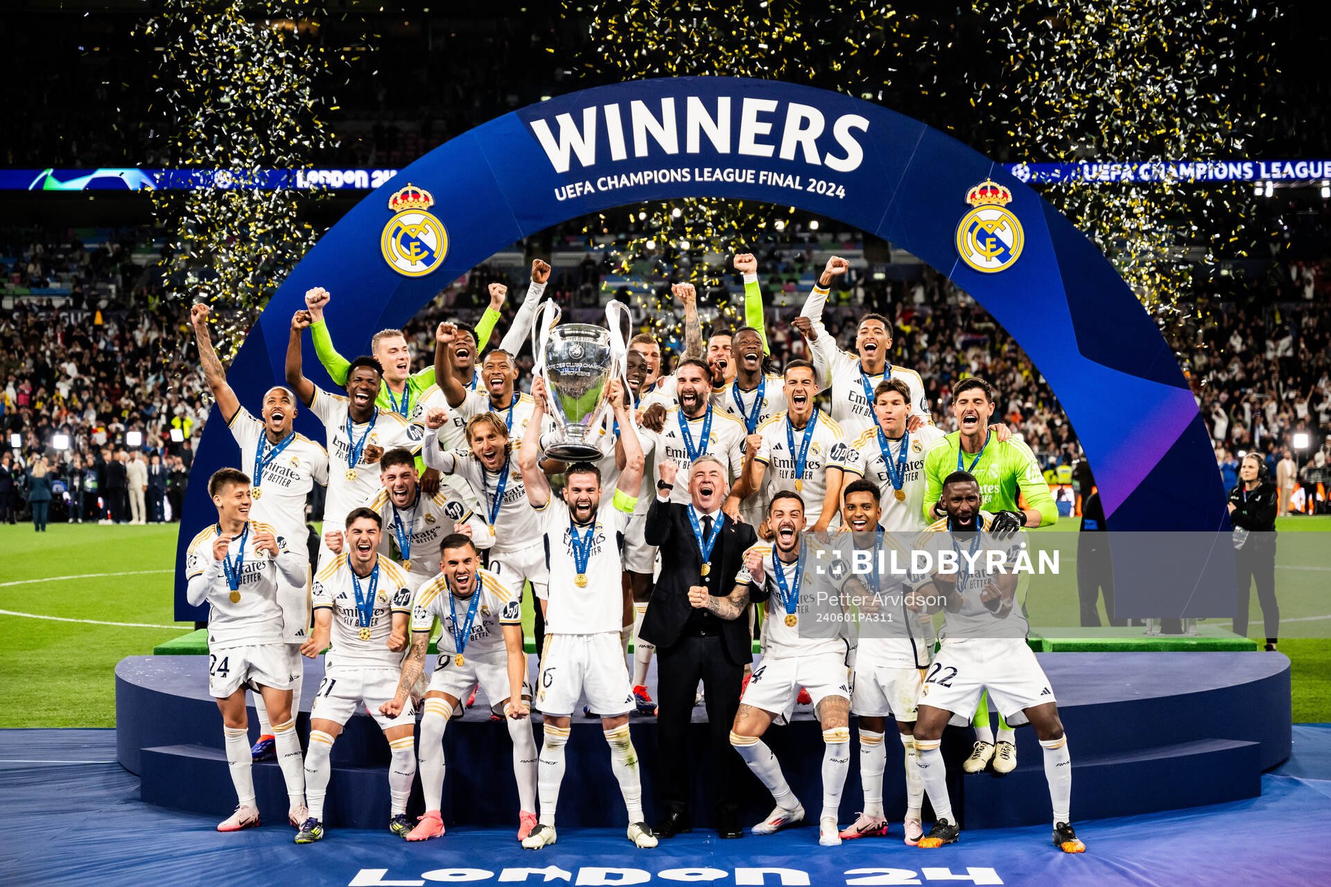 Nacho Fernandez of Real Madrid lifts the trophy