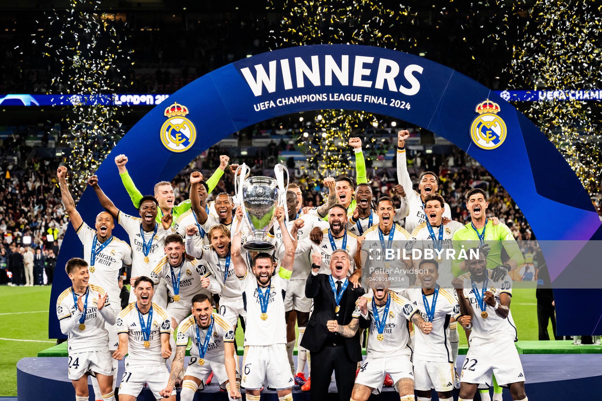 Nacho Fernandez of Real Madrid lifts the trophy