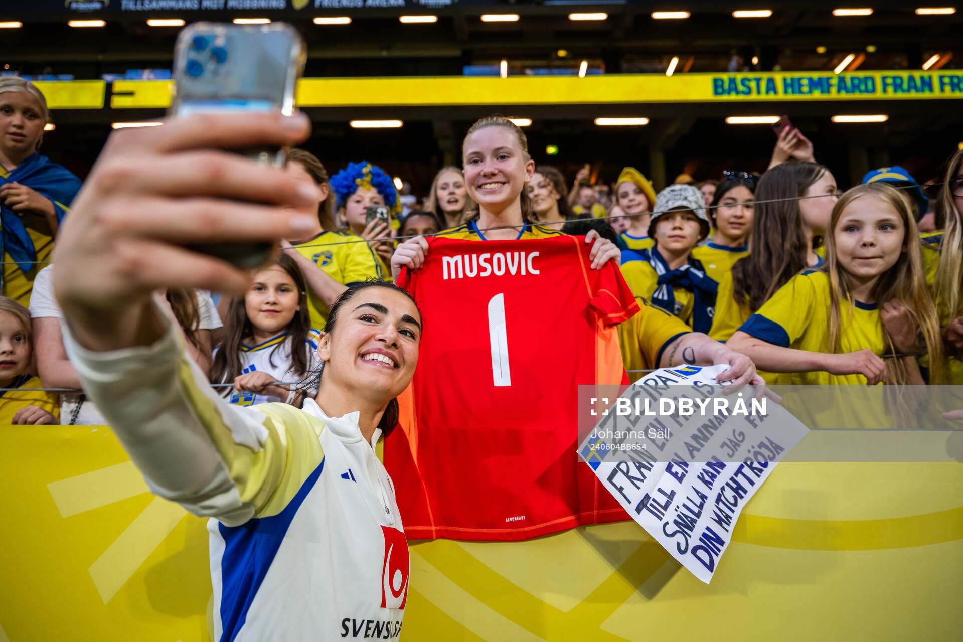Goalkeeper Zecira Musovic of Sweden takes photos with fans
