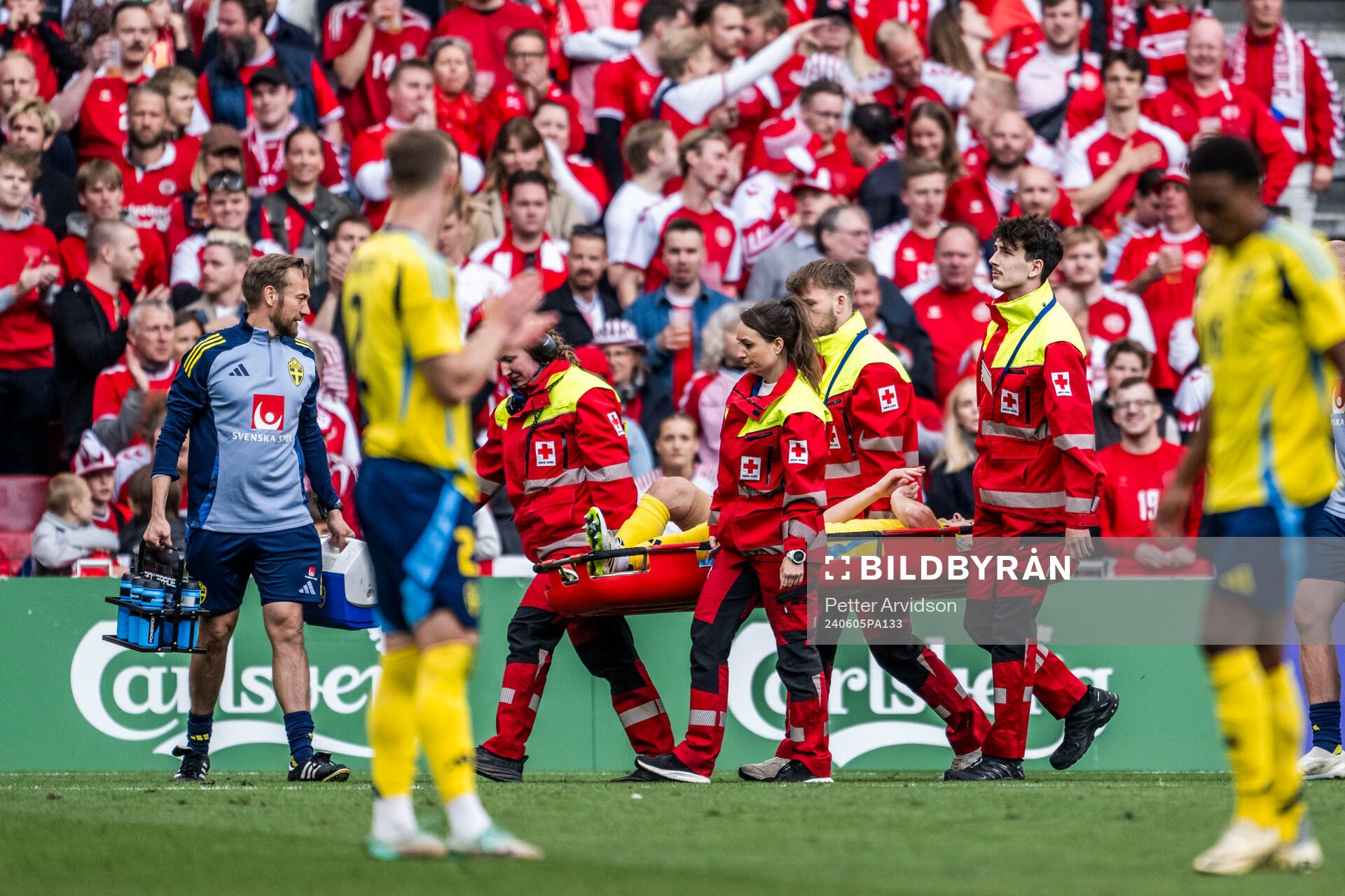 Hjalmar Ekdal of Sweden is carried of the pitch