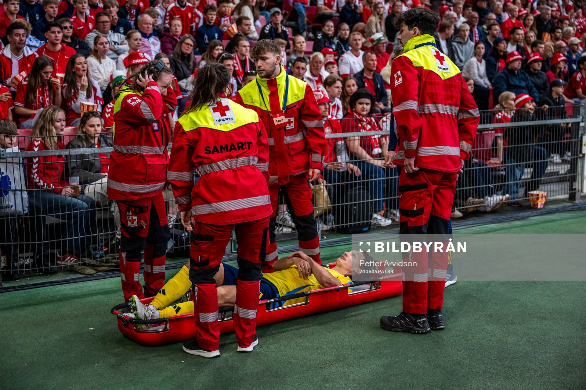 Hjalmar Ekdal of Sweden is carried of the pitch