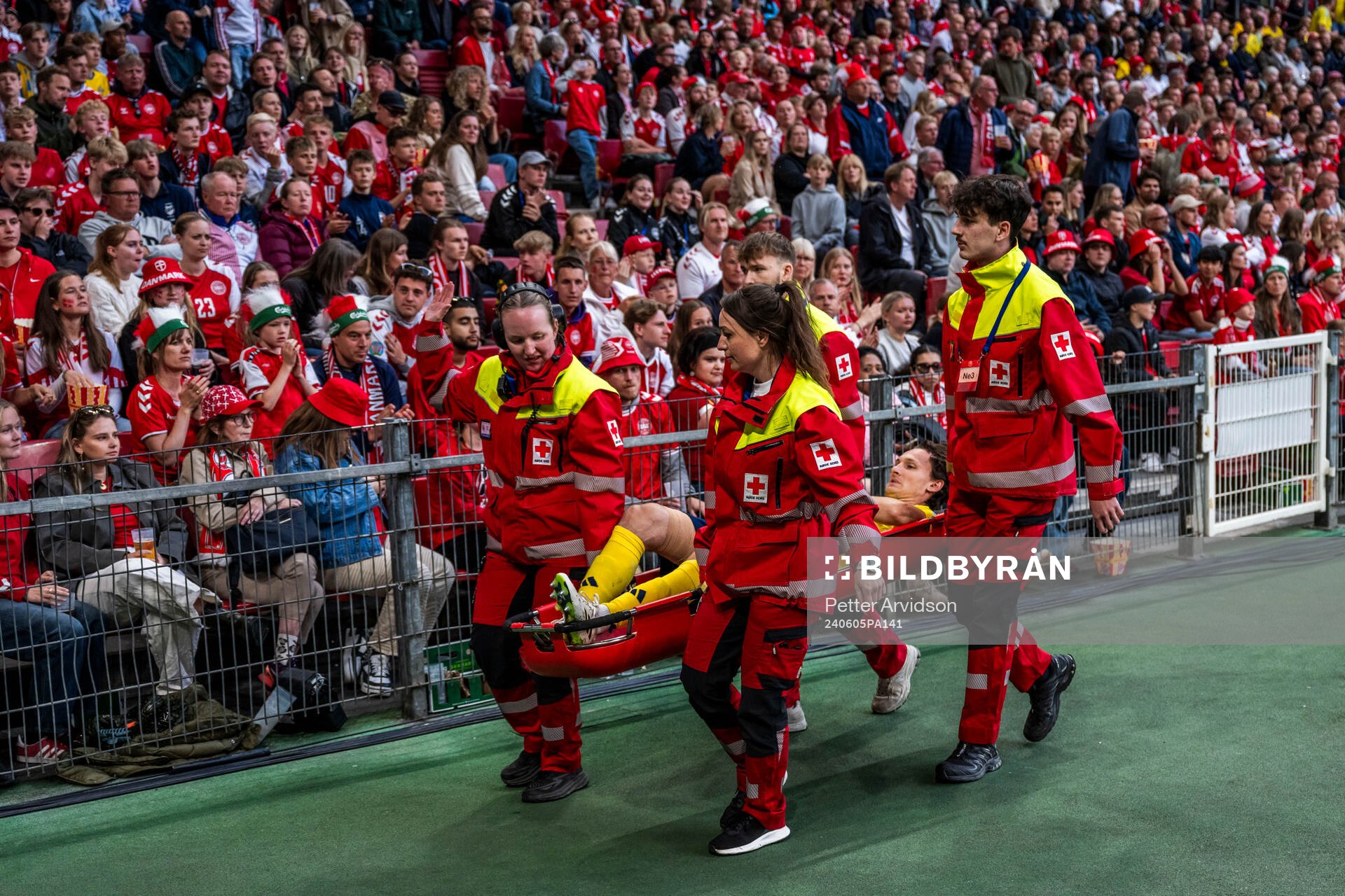 Hjalmar Ekdal of Sweden is carried of the pitch