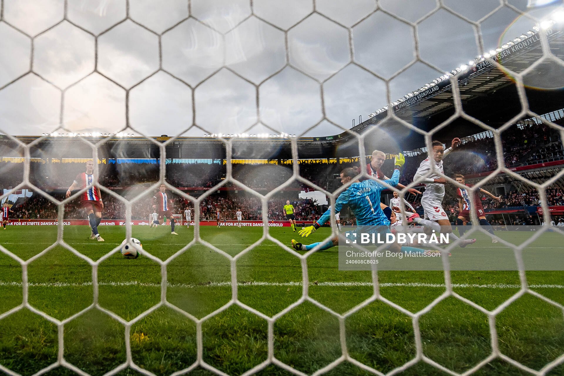 Yussuf Poulsen of Denmark scores 3-1 behind goalkeeper