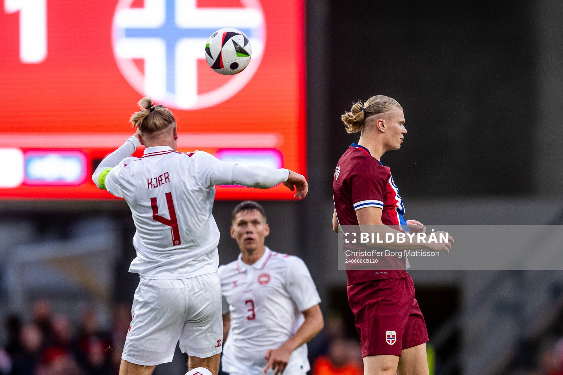 Simon Kjær of Denmark and Erling Braut Haaland of Norway