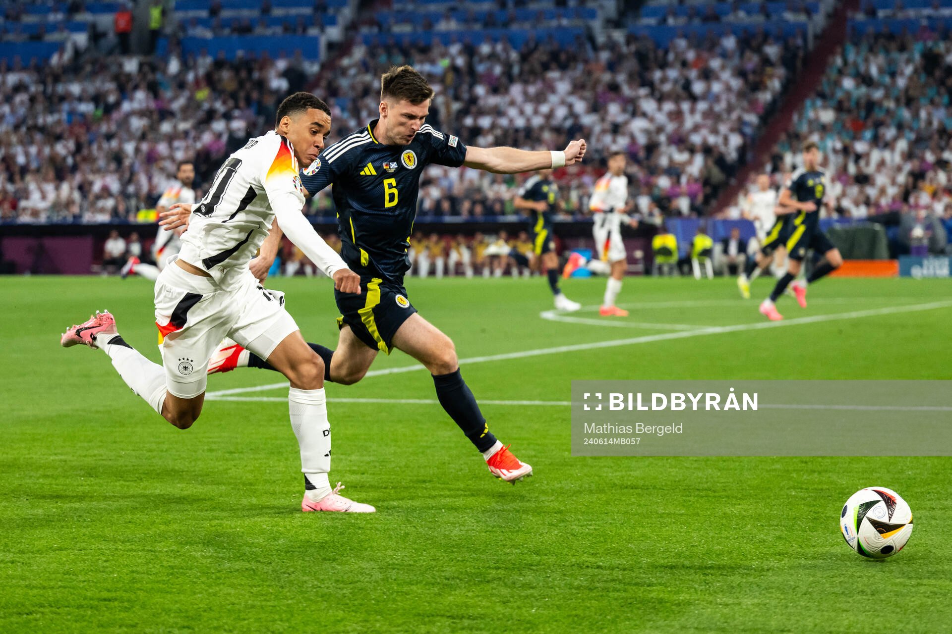 Jamal Musiala of Germany and Kieran Tierney of Scotland