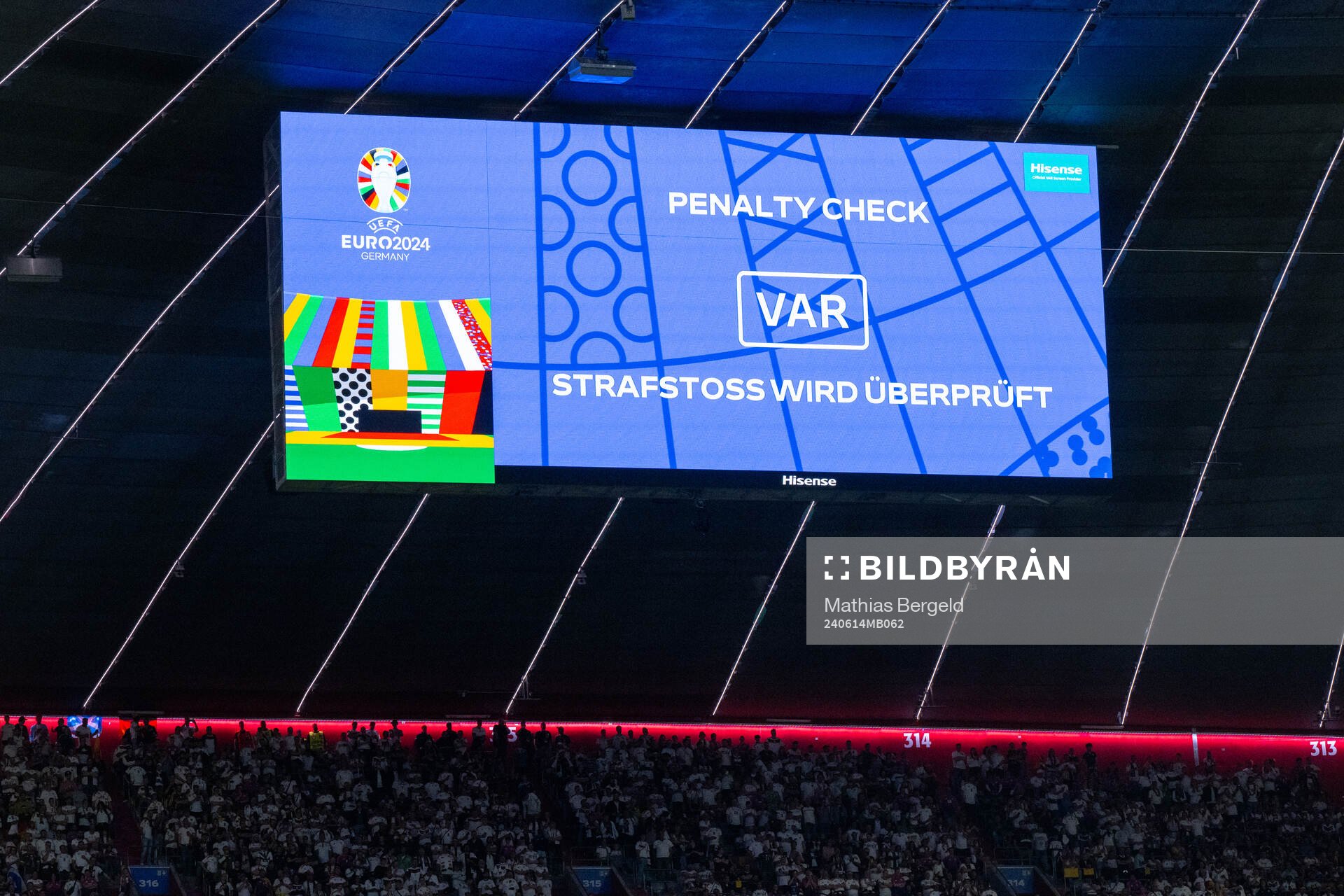 A big screen displays a VAR review message