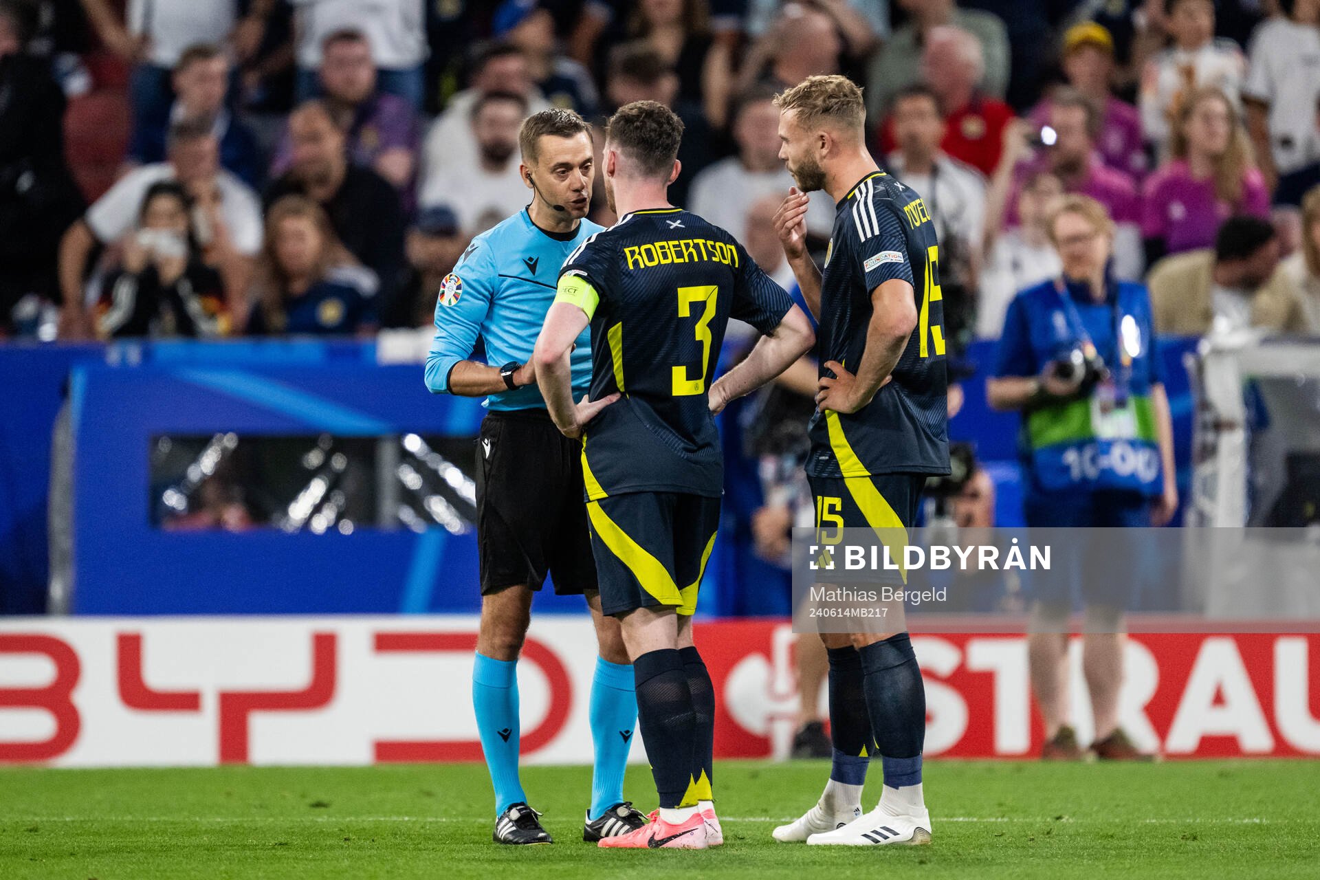 Referee Clément Turpin talks to Andrew Robertson and Ryan