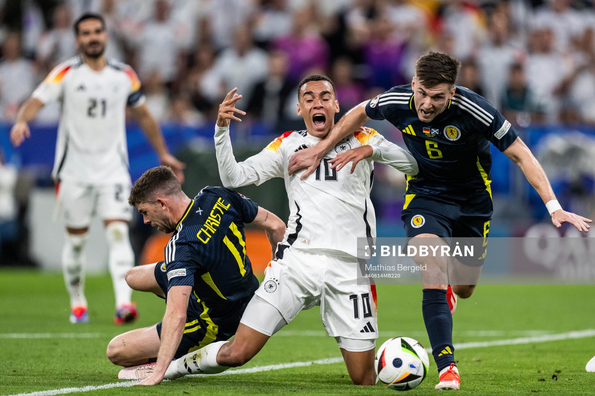 Ryan Christie and Kieran Tierney of Scotland compete for