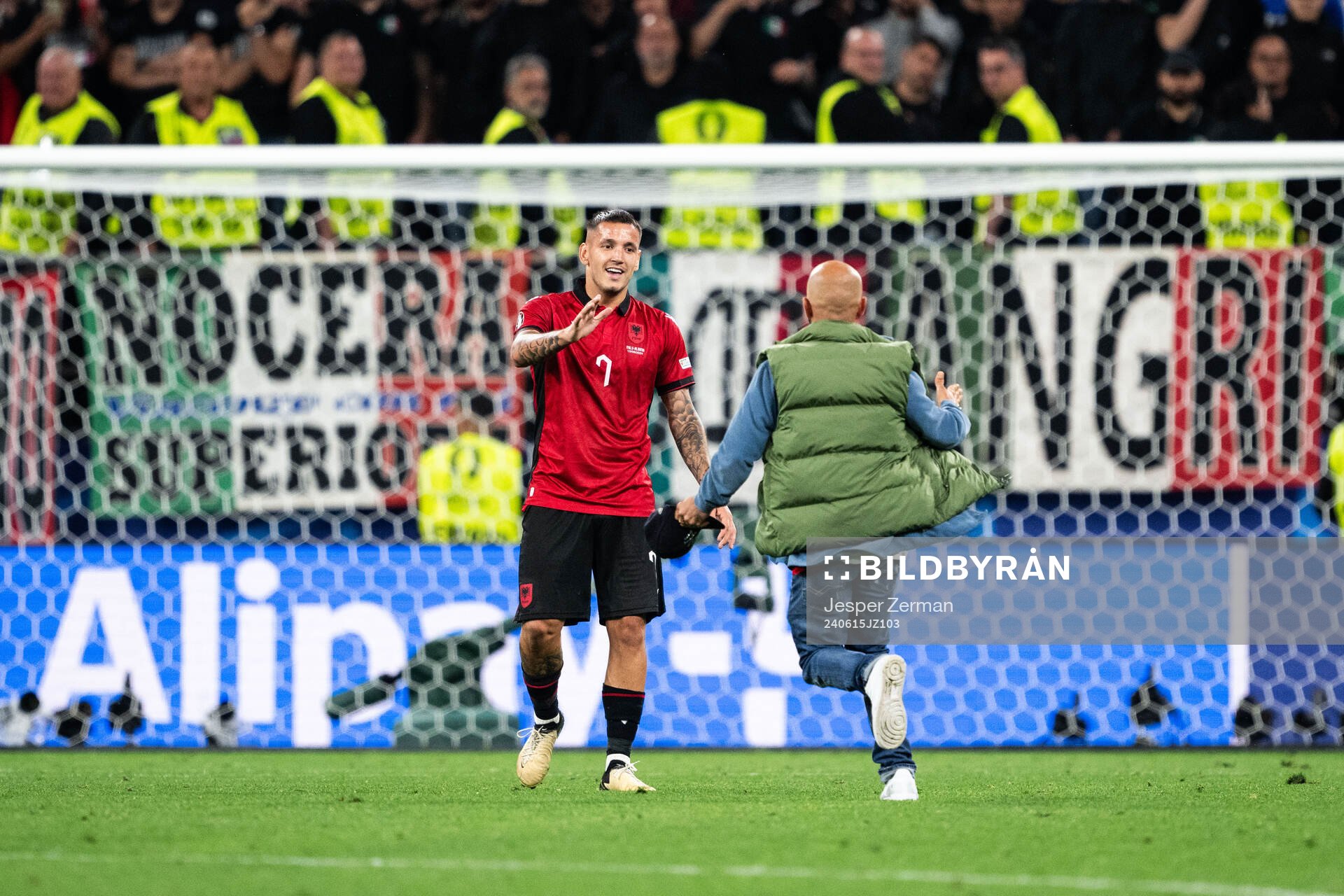 Rey Manaj of Albania and a pitch invader