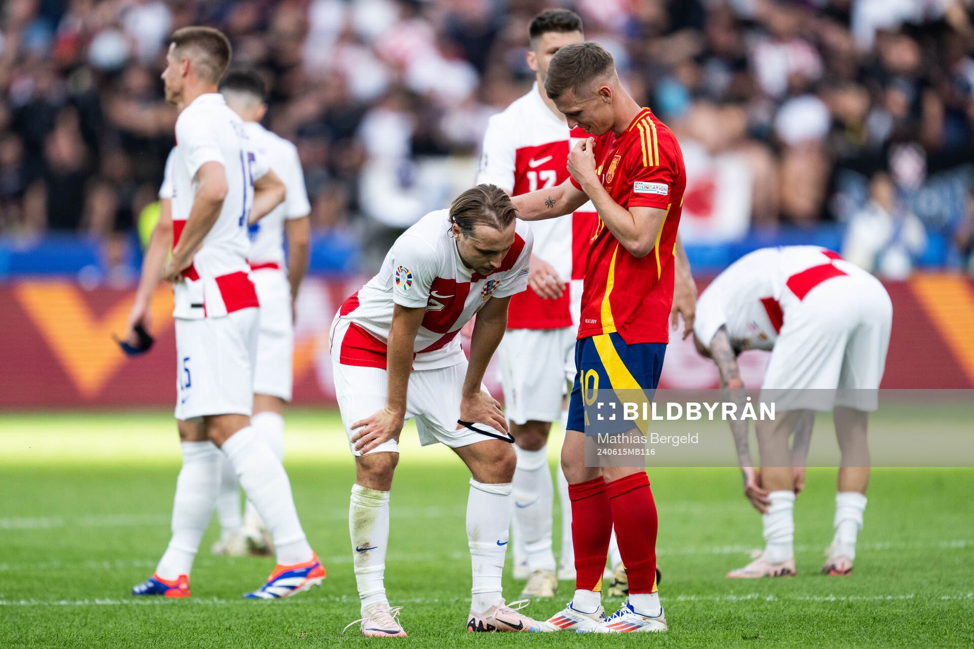 Daniel Olmo of Spain consoles Lovro Majer of Croatia