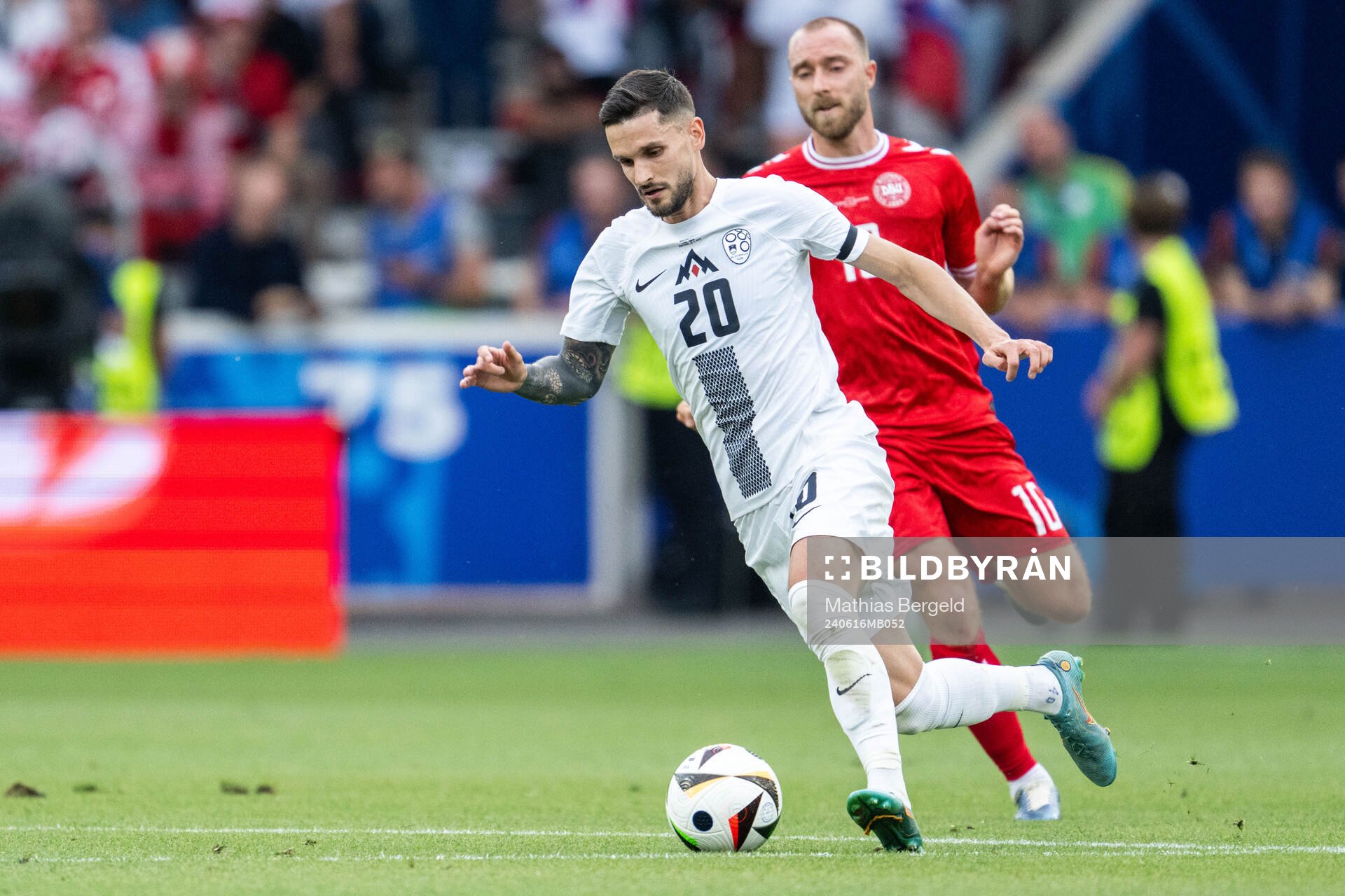 Petar Stojanovic of Slovenia and Christian Eriksen of