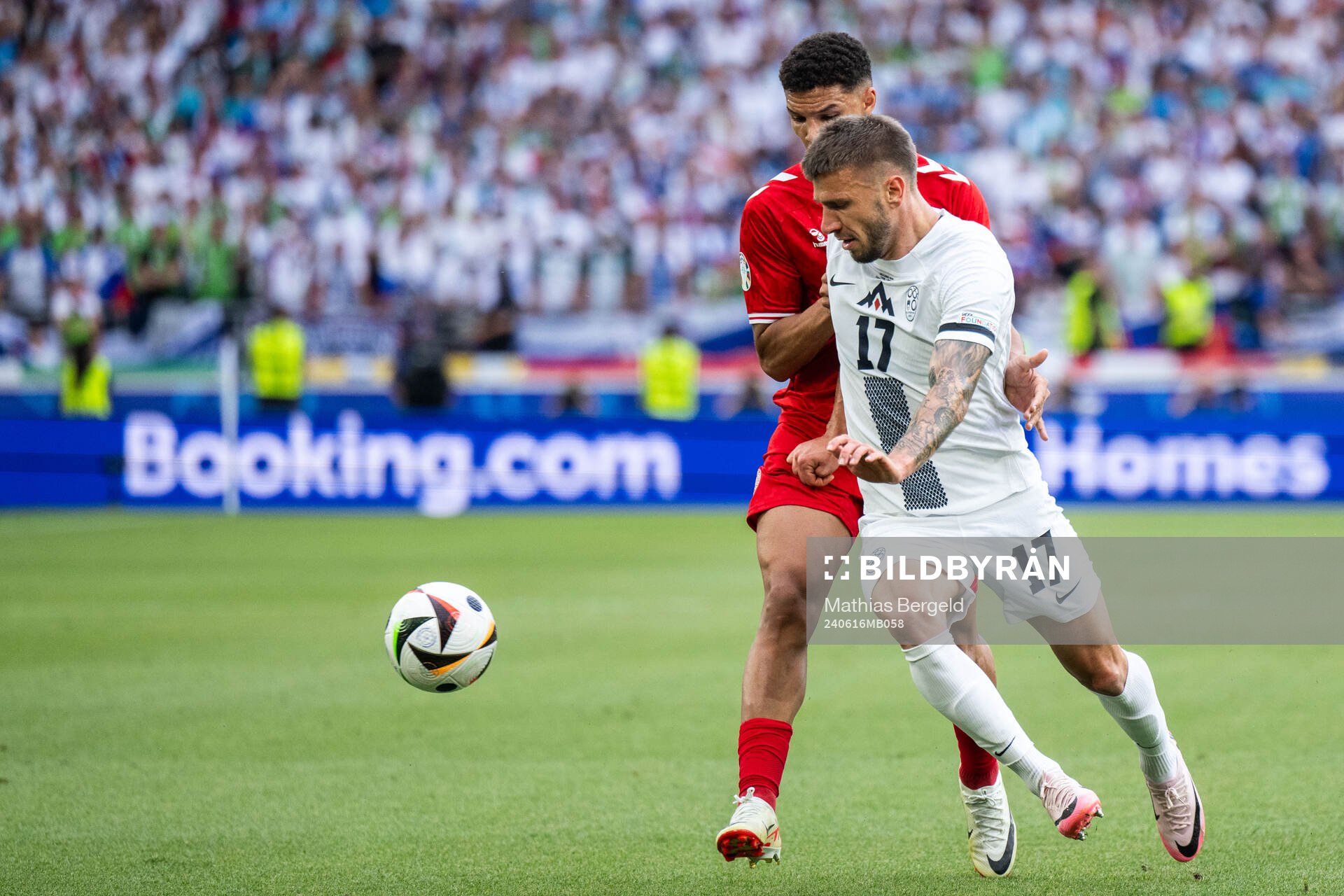 Jan Mlakar of Slovenia and Alexander Bah of Denmark during the UEFA Euro 2024 Football Championship match between Slovenia and Denmark on June 16, 2024 in Stuttgart.