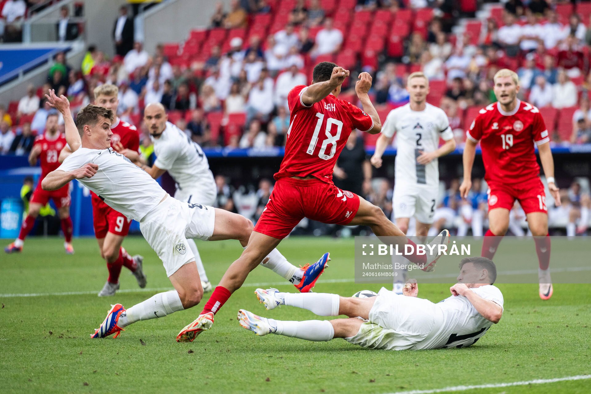 Jaka Bijol and Erik Janza of Slovenia against Alexander Bah of Denmark during the UEFA Euro 2024 Football Championship match between Slovenia and Denmark on June 16, 2024 in Stuttgart.