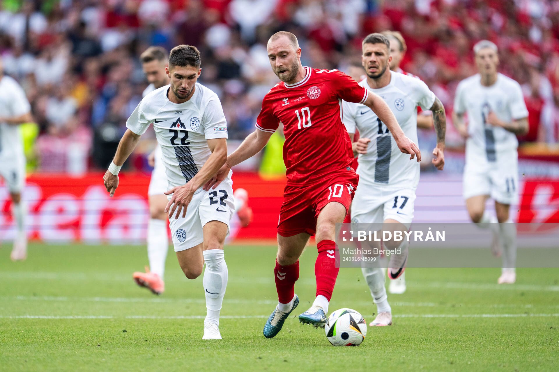 Adam Cerin of Slovenia and Christian Eriksen of Denmark