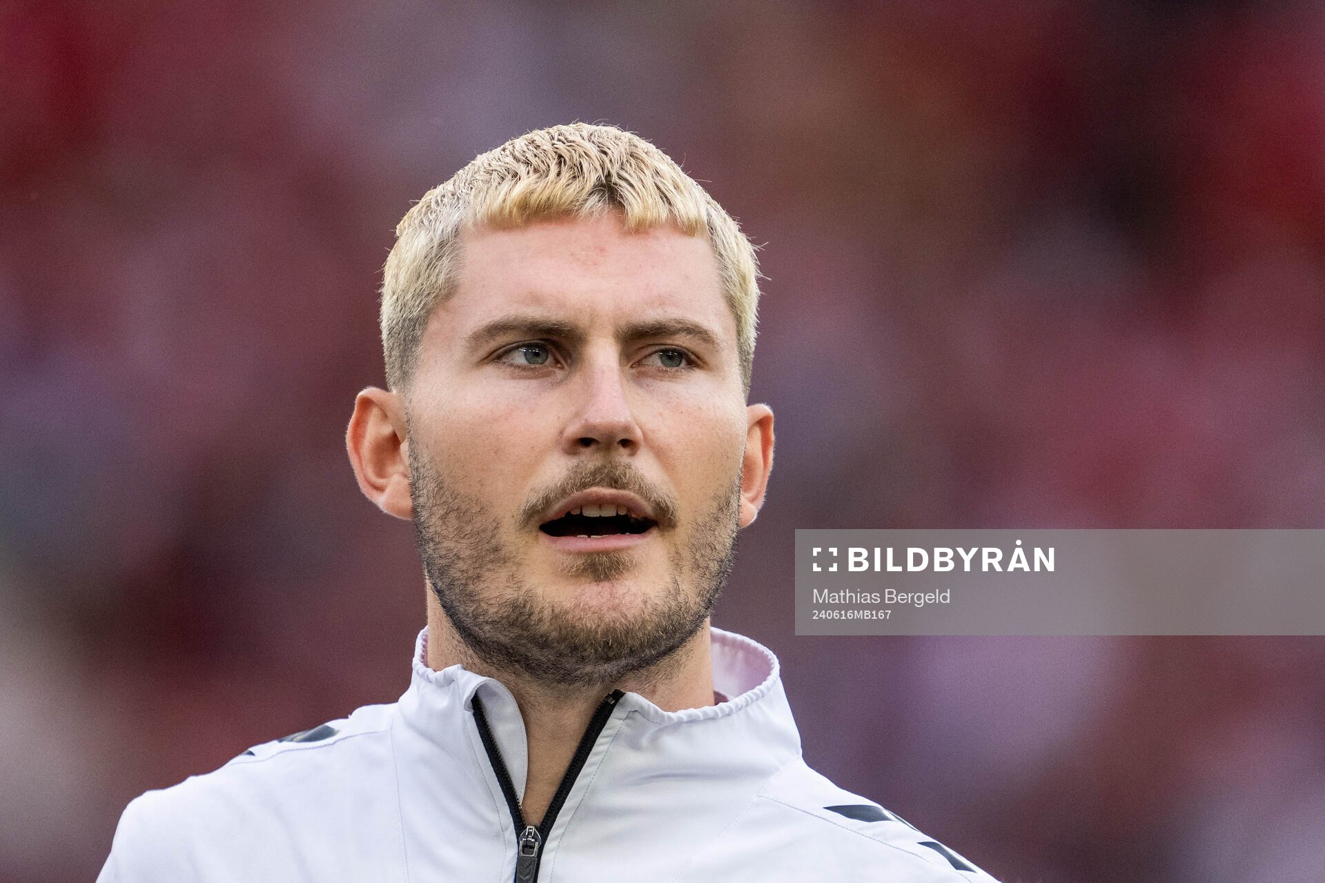 Jonas Wind of Denmark sings the national anthem