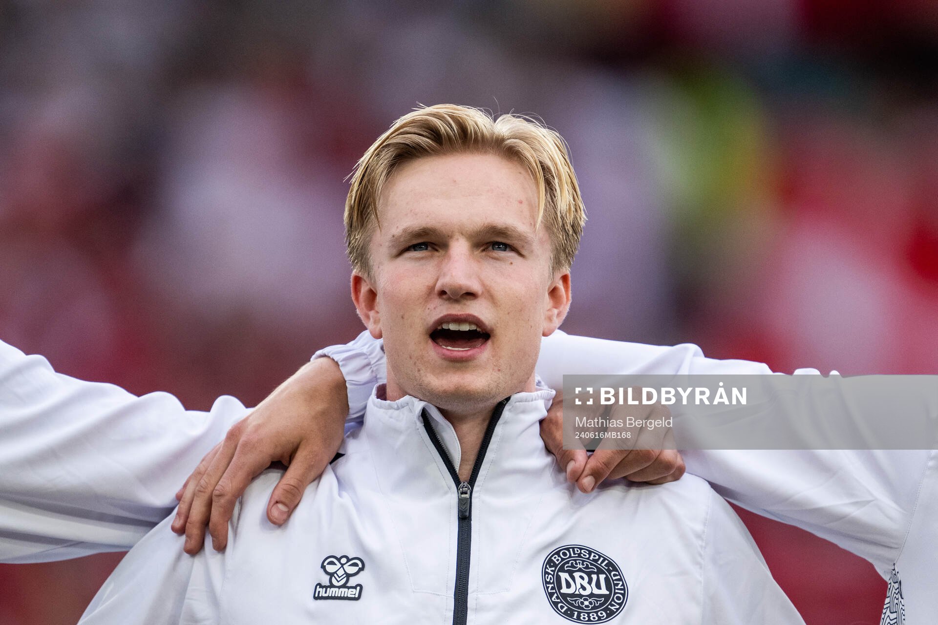 Victor Kristiansen of Denmark sings the national anthem