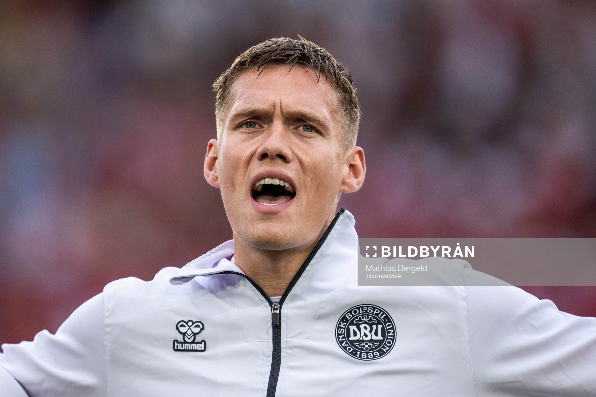 Jannik Vestergaard of Denmark sings the national anthem