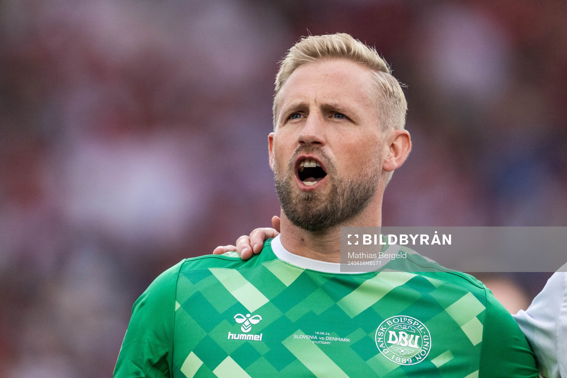 Goalkeeper Kasper Schmeichel of Denmark sings the national
