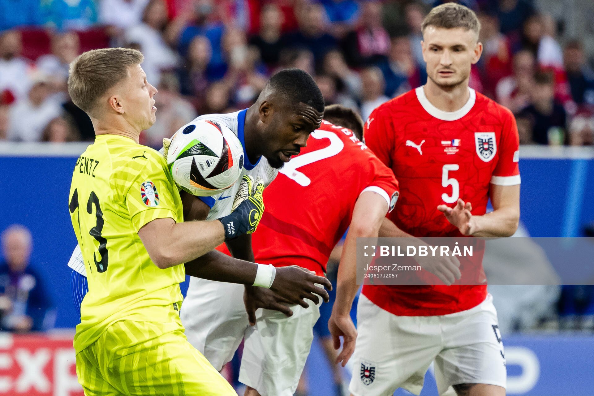 Goalkeeper Patrick Pentz of Austria and Marcus Thuram of