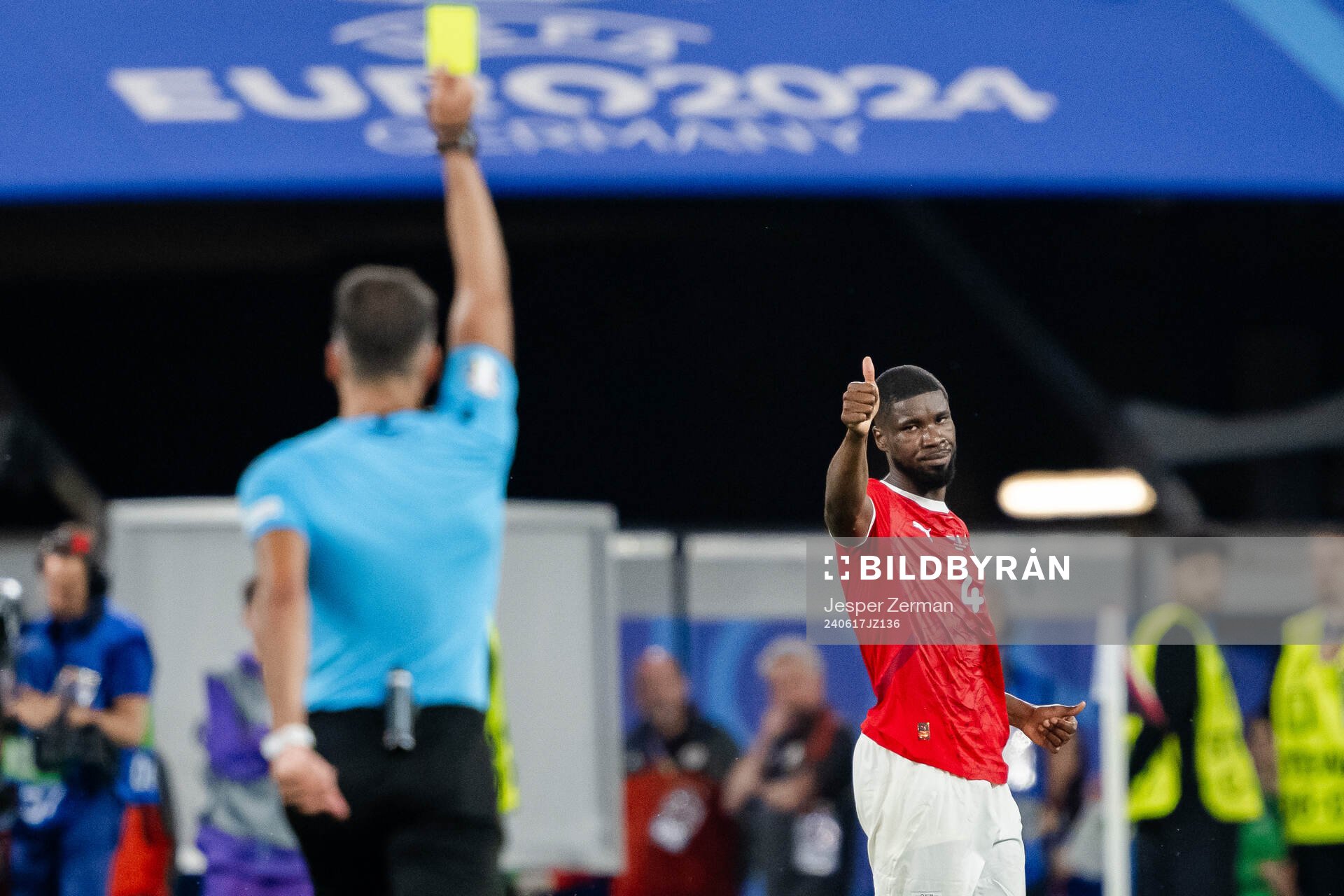 Kevin Danso of Austria receives a yellow card