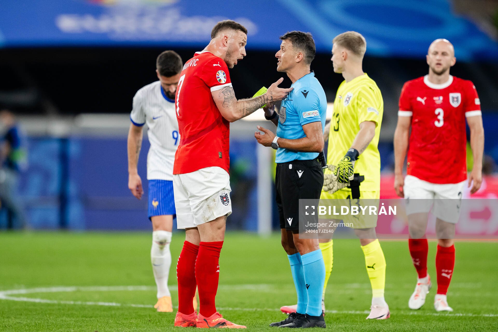 Marko Arnautovic of Austria and referee Jesus Gil Manzano