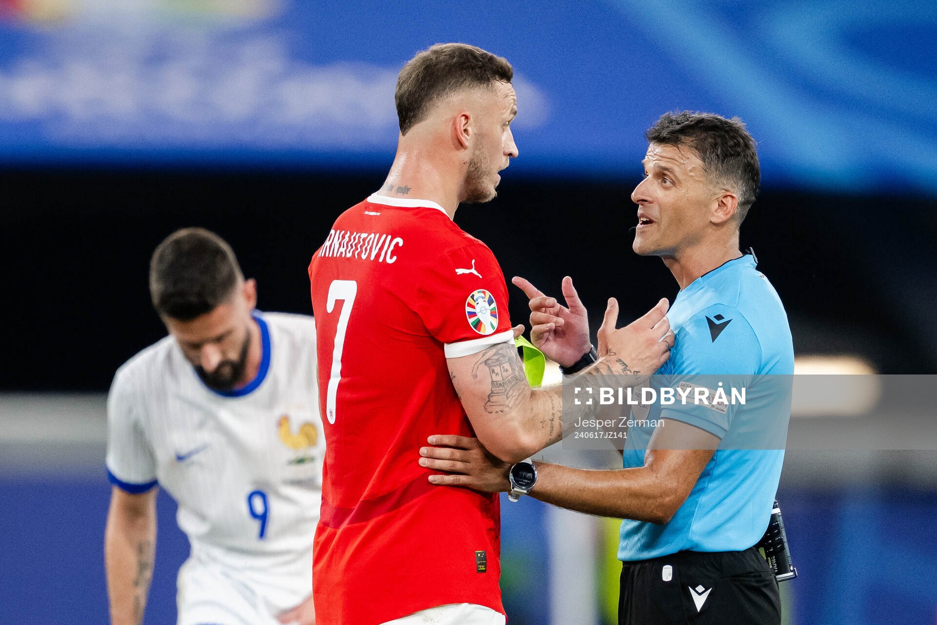 Marko Arnautovic of Austria and referee Jesus Gil Manzano