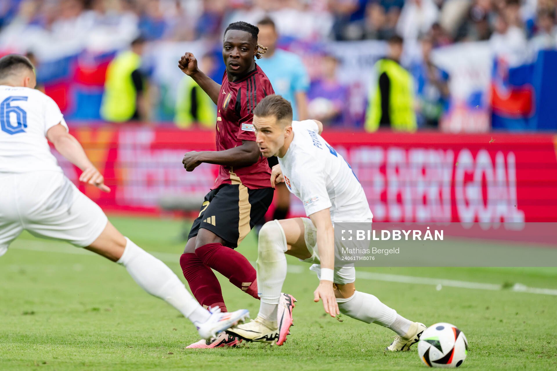 Jeremy Doku of Belgium and Peter Pekarik of Slovakia