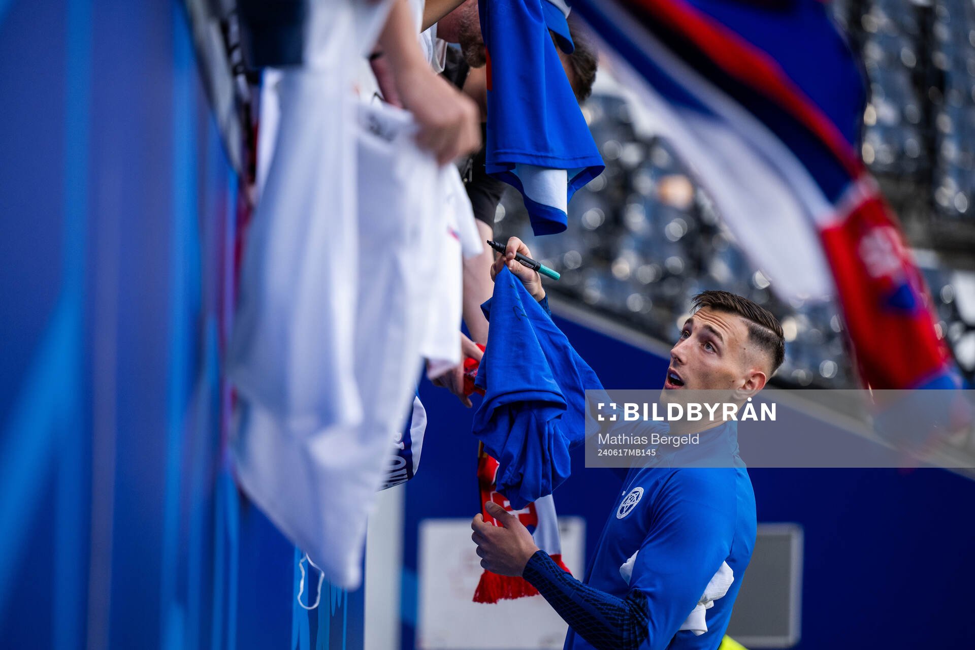 Robert Bozenik of Slovakia signs autographs