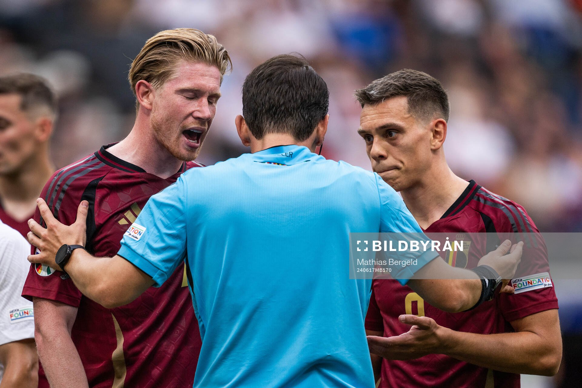Kevin De Bruyne and Leandro Trossard of Belgium react