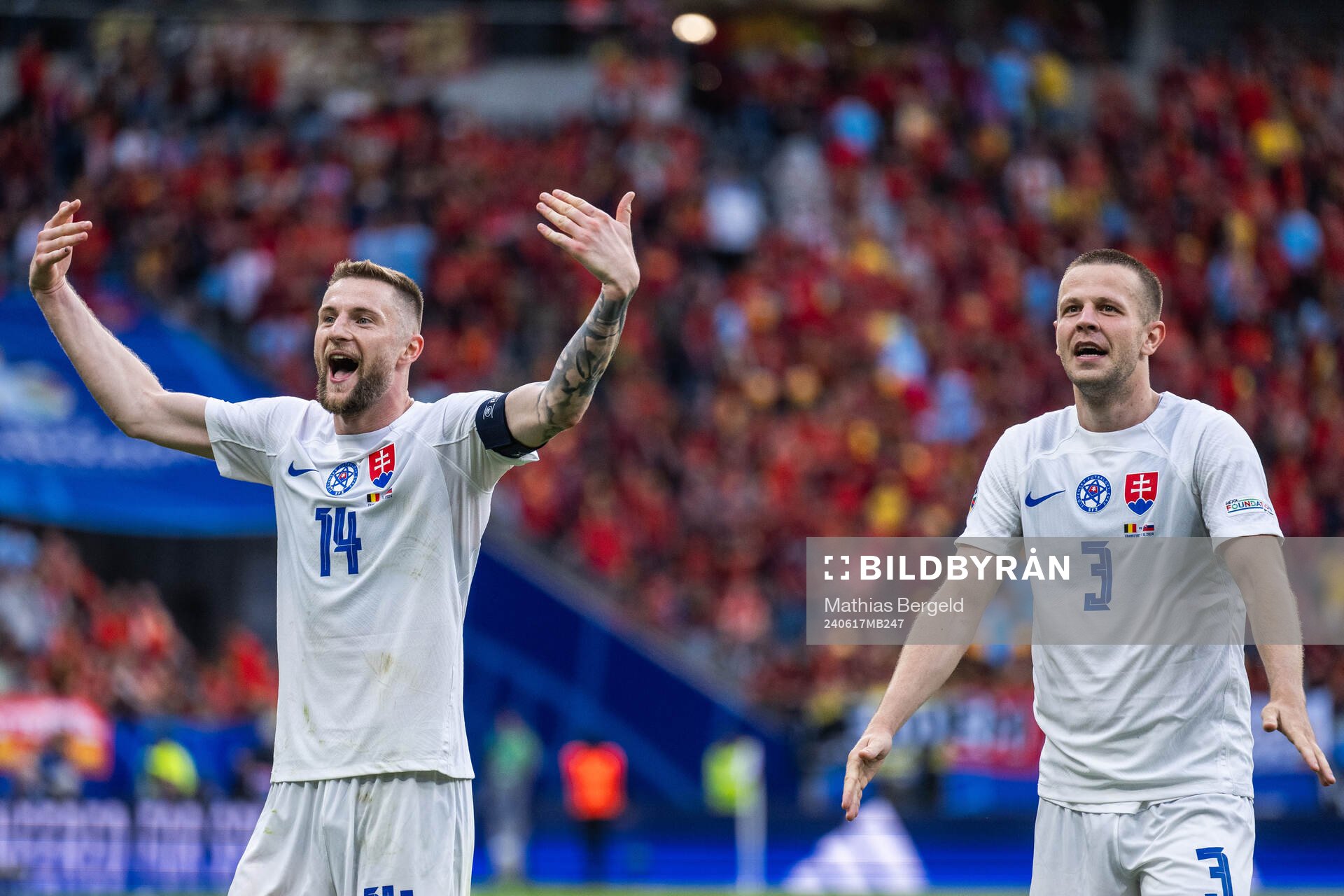 Milan Skriniar and Denis Vavro of Slovakia celebrate