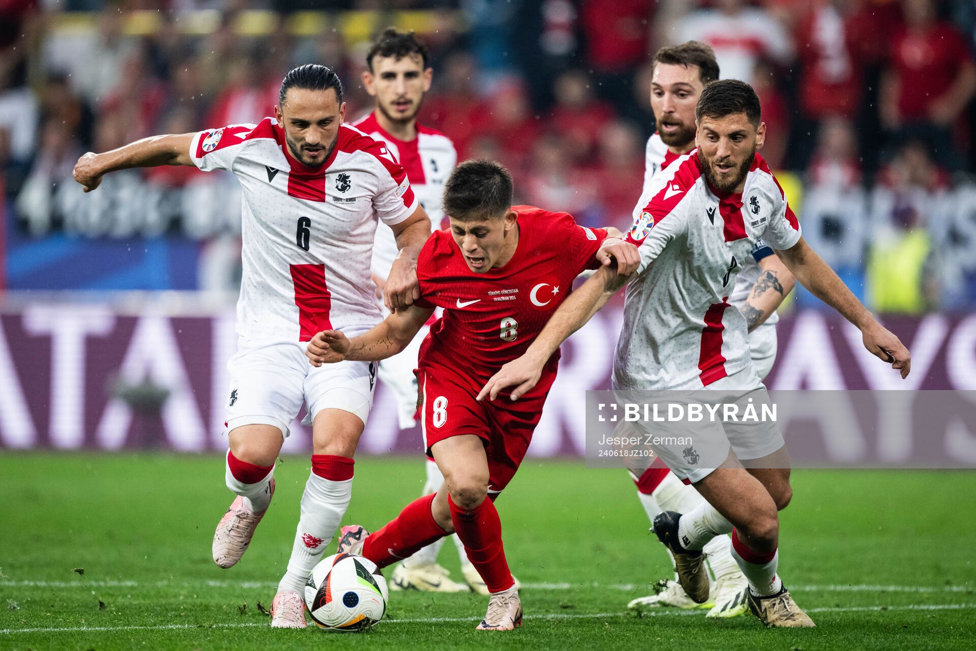 Giorgi Kochorashvili and Lasha Dvali of Georgia against Arda Guler of Türkiye during the UEFA Euro 2024 Football Championship match between Türkiye and Georgia on June 18, 2024 in Dortmund.