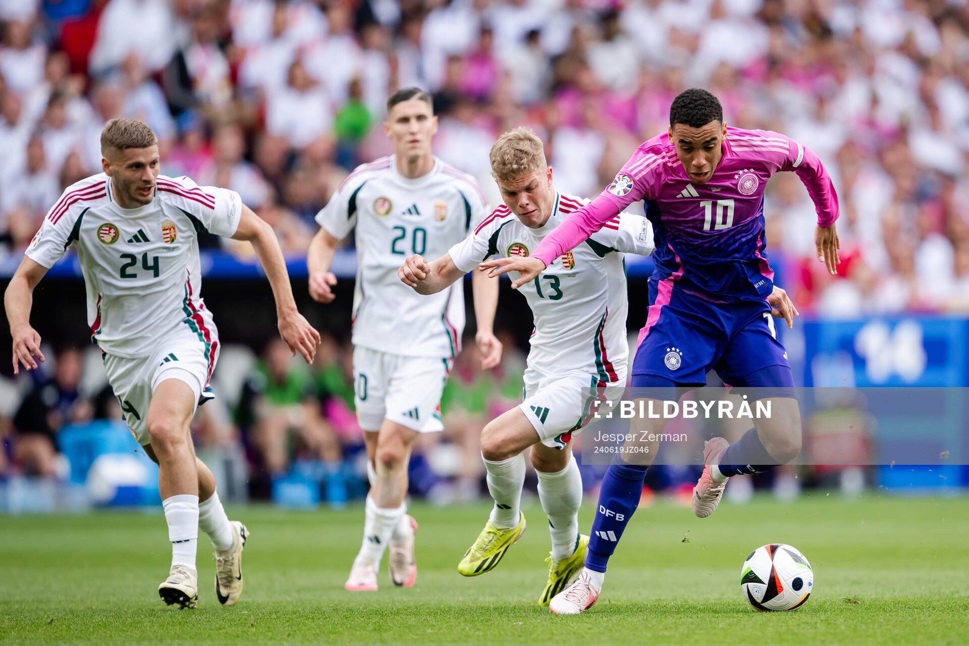 Marton Dardai , Roland Sallai and Andras Schäfer of Hungary against Jamal Musiala of Germany during the UEFA Euro 2024 Football Championship match between Germany and Hungary on June 19, 2024 in Stuttgart.